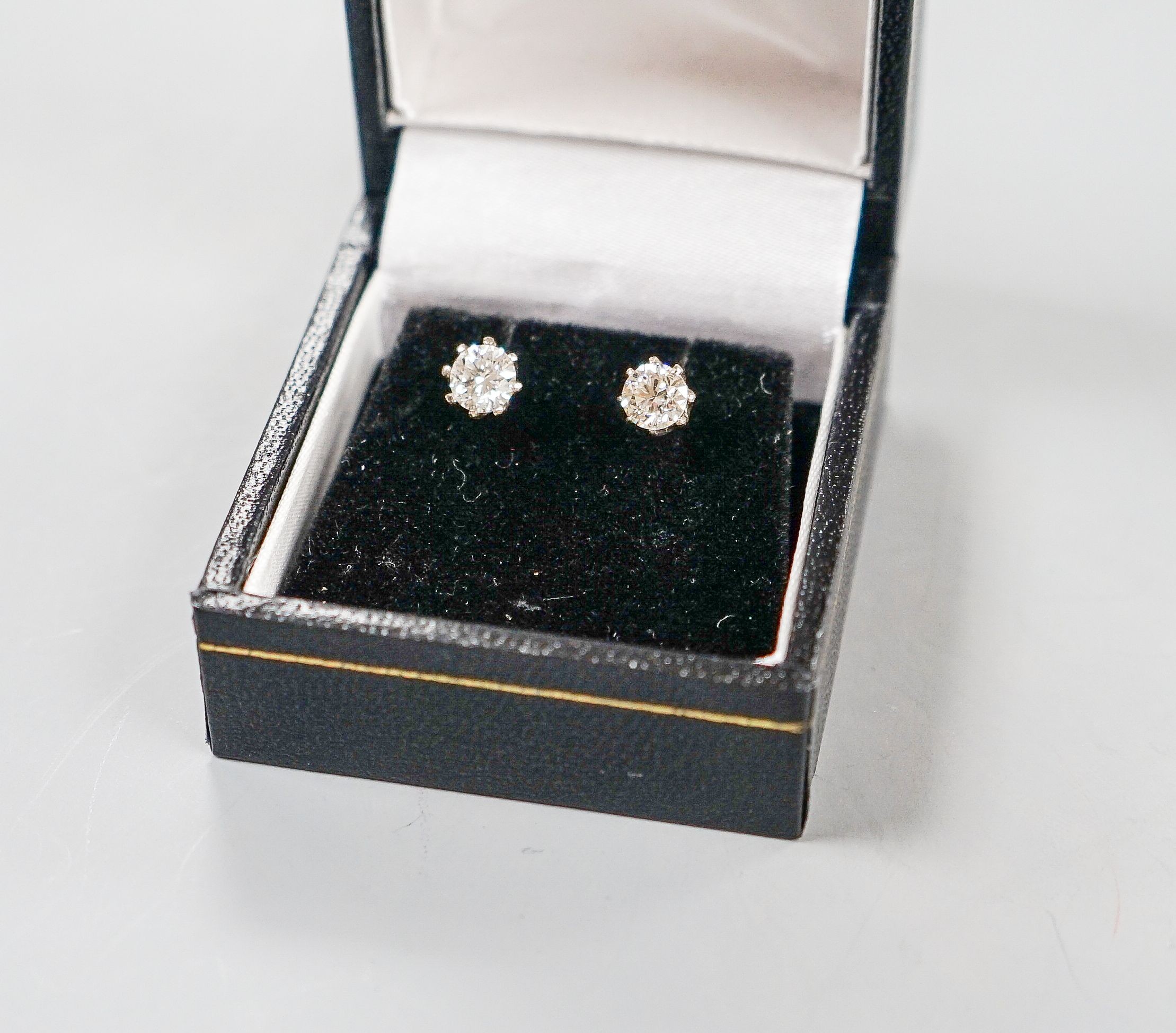 A pair of 18ct white metal and solitaire diamond ear studs, gross weight 2.4 grams